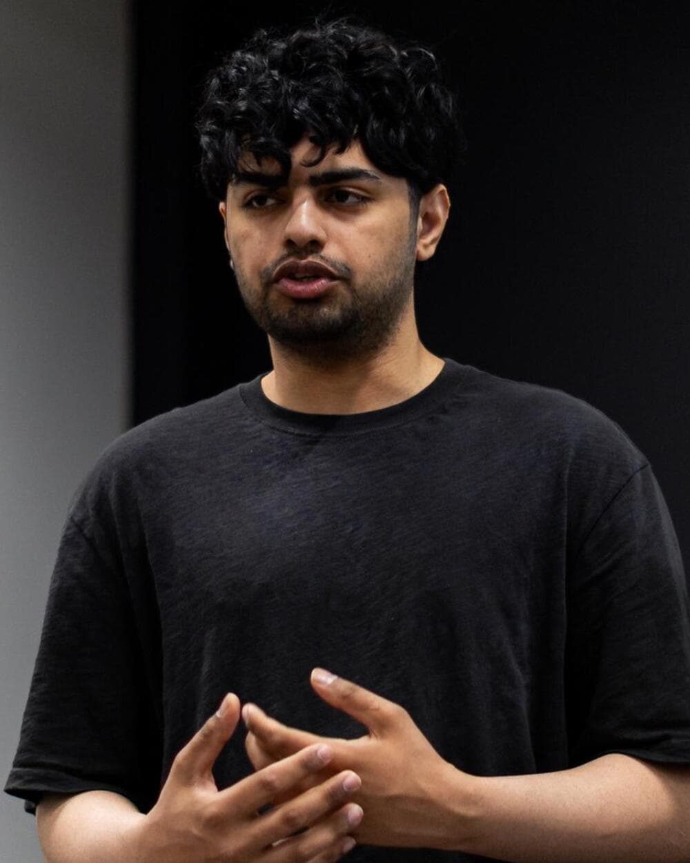 Saad presenting, talking with his hands.
