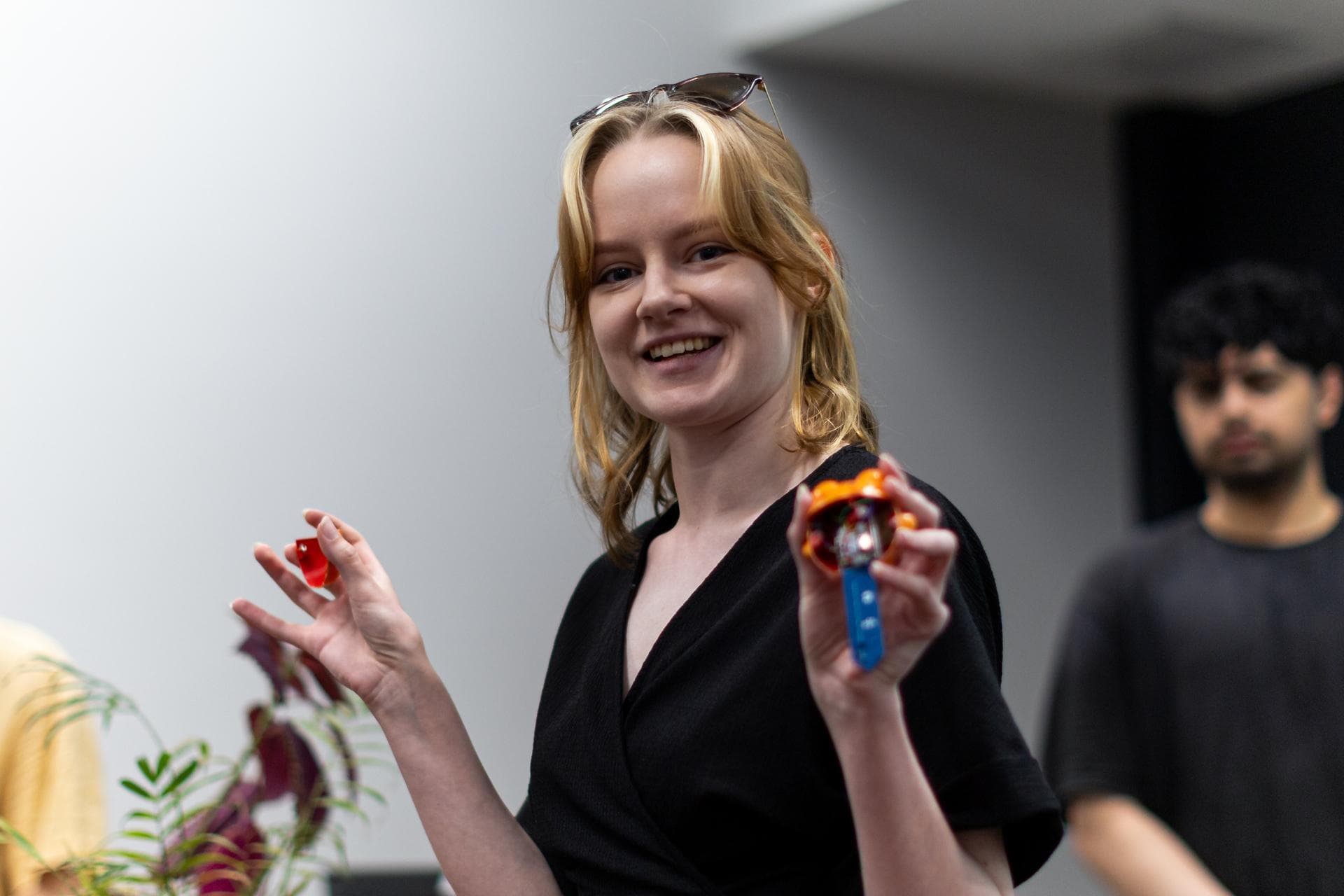 Mira holding a Sprooty frog with its shell opened, showing the small circuit board inside.